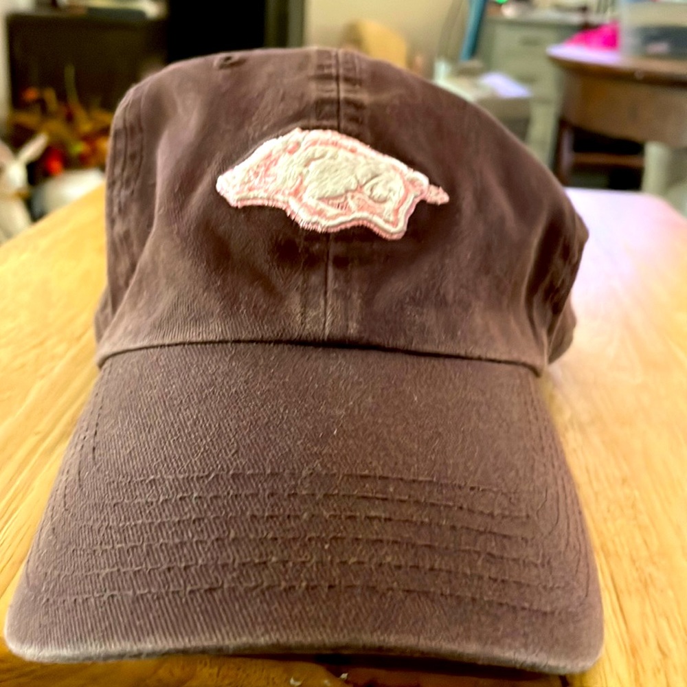 Razorback lid. Brown with pink outline Arkansas embroidered. On back capital A.